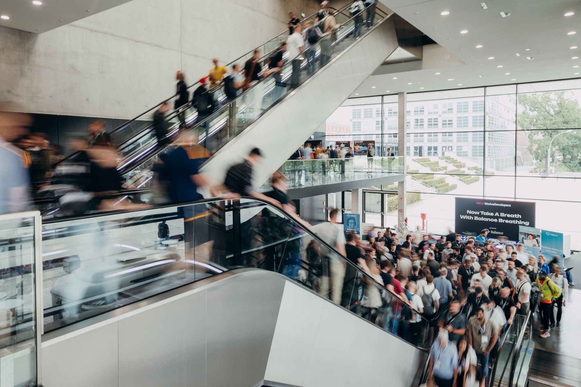 Attendees crowding the escalators and foyer at WeAreDevelopers World Congress 2026