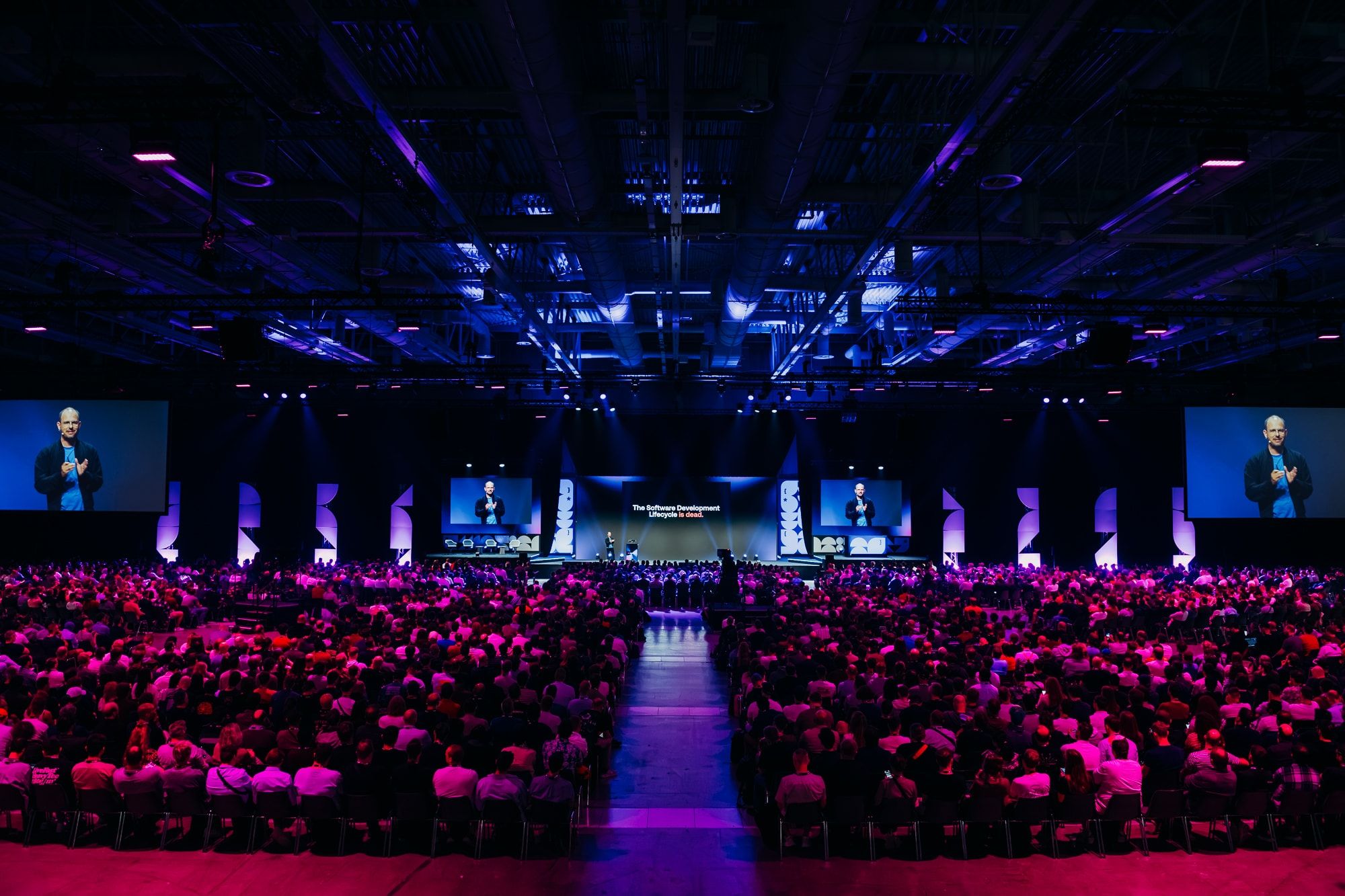 Packed main hall at WeAreDevelopers World Congress 2026 under blue and pink stage lighting