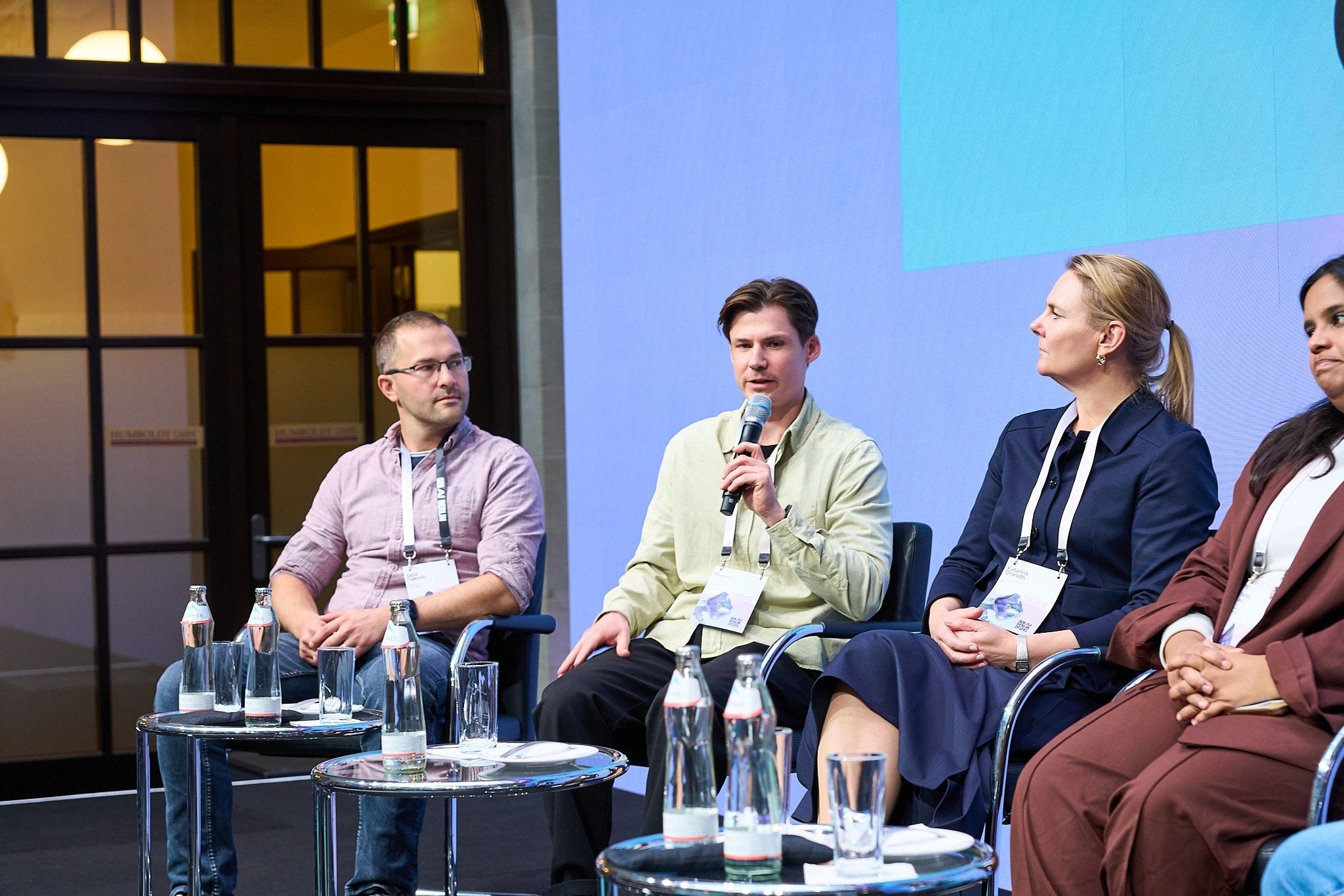 Close view of the panel at GenAI Berlin 2026, with Sasa Fajkovic on the far left listening to another panellist