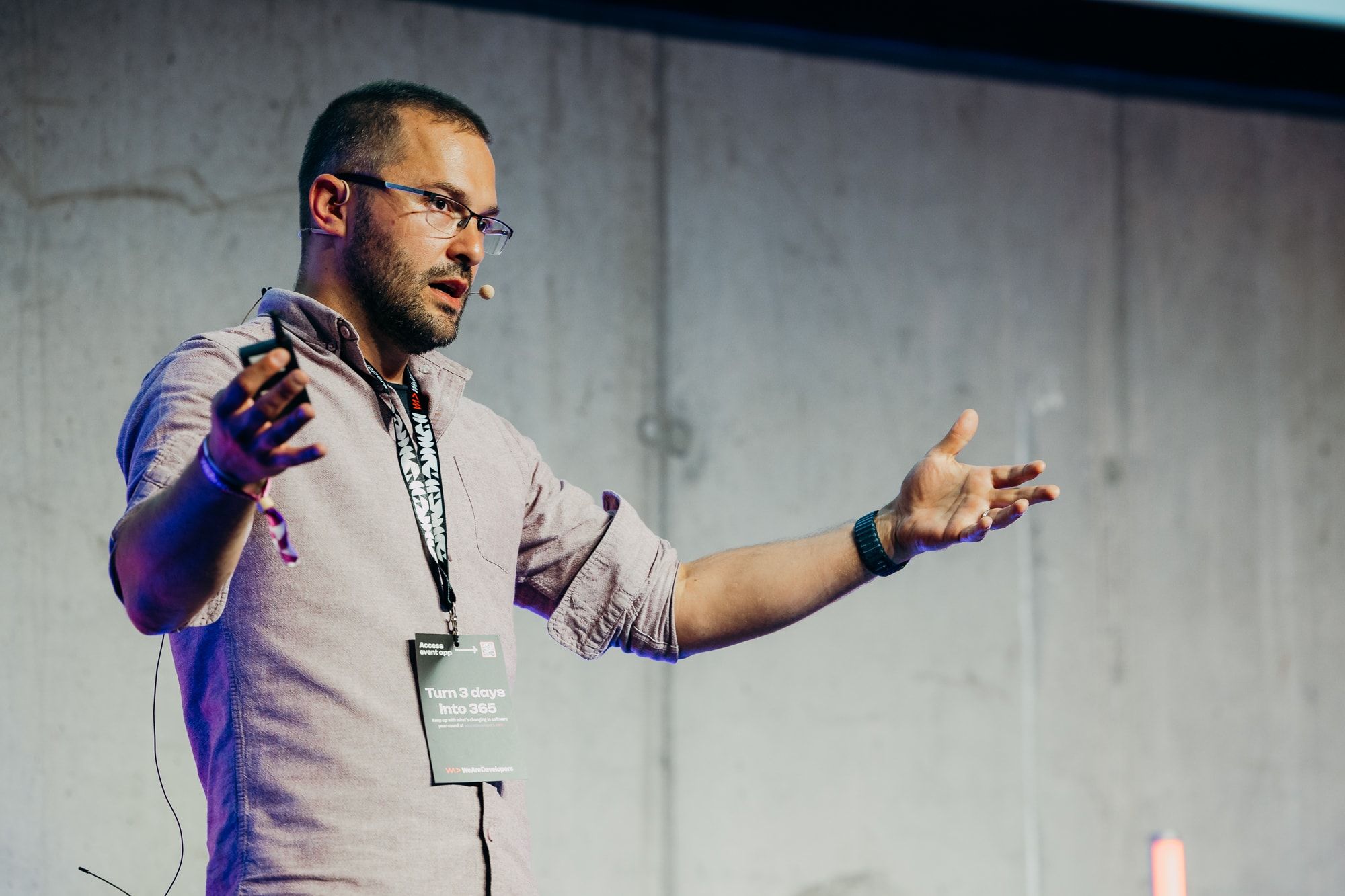 Close view of Sasa Fajkovic presenting with both arms open at WeAreDevelopers World Congress 2026
