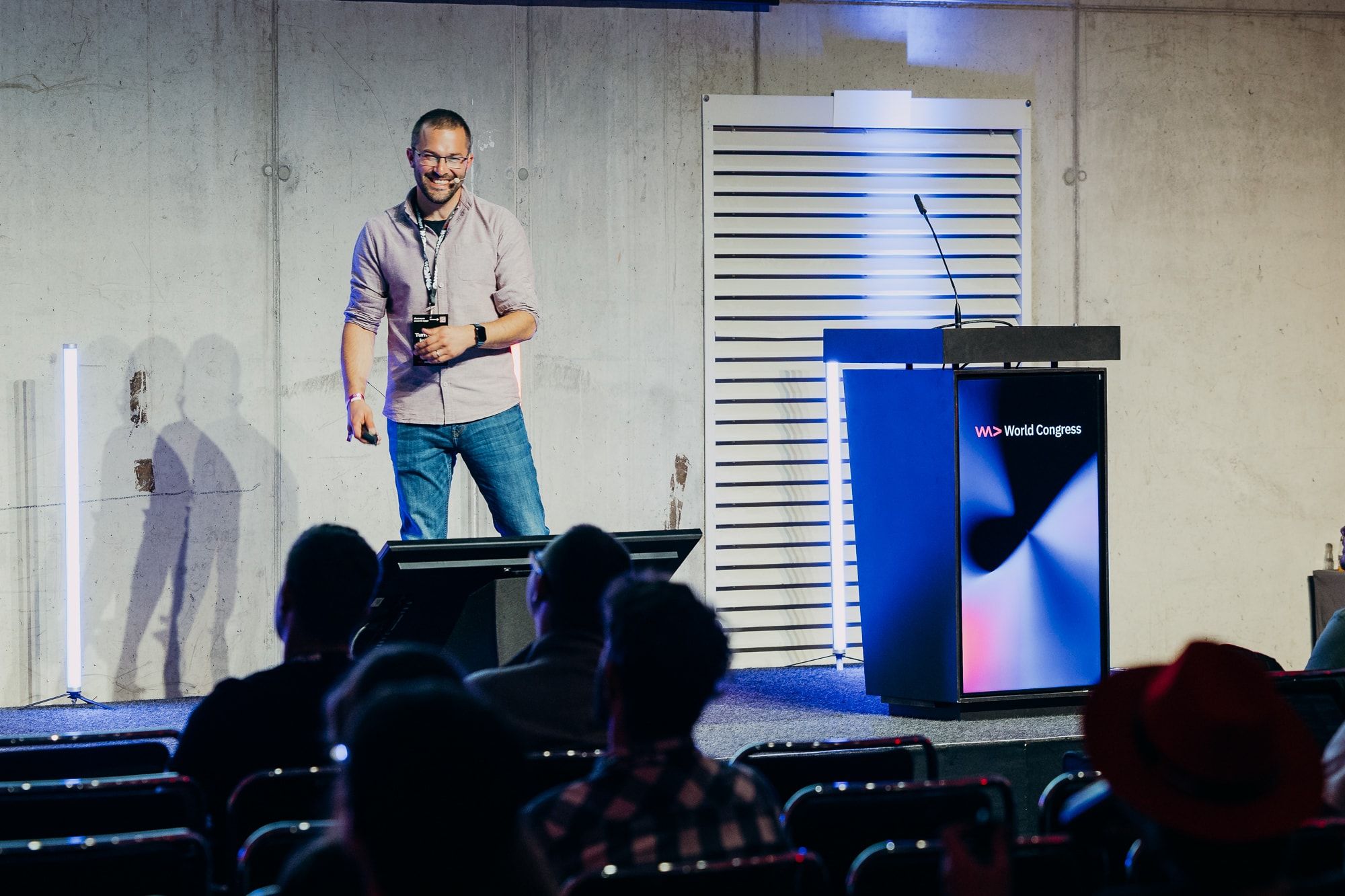 Sasa Fajkovic smiling on stage beside the World Congress lectern at WeAreDevelopers World Congress 2026, with the audience in the foreground