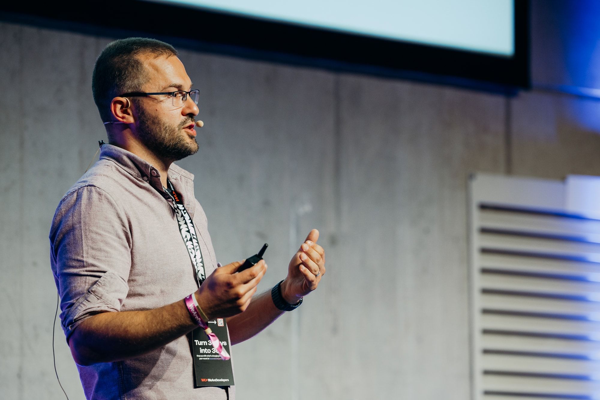 Close view of Sasa Fajkovic explaining a point with a headset microphone at WeAreDevelopers World Congress 2026
