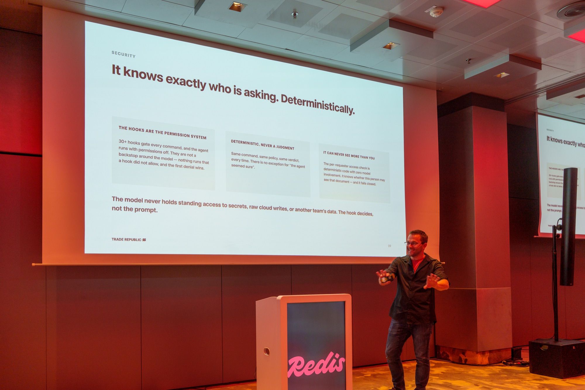 Sasa Fajkovic presenting a security slide titled “It knows exactly who is asking. Deterministically.” at the Redis AI Roadshow in Munich