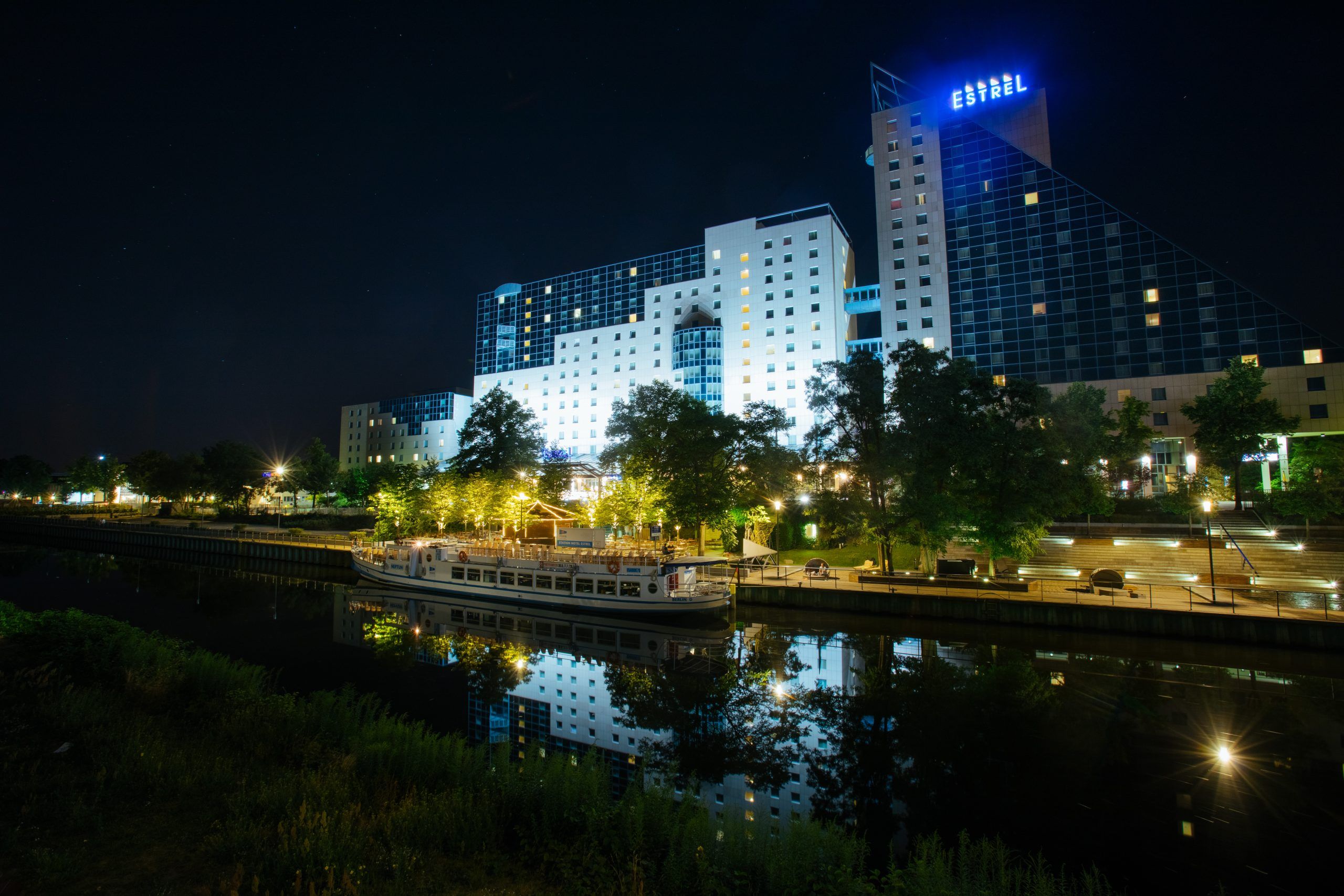 Estrel Congress Center in Berlin at night, reflected in the canal